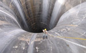 Brian Hollis rappels into Gibson Dam glory hole spillway. Photo by Joe Rohde
